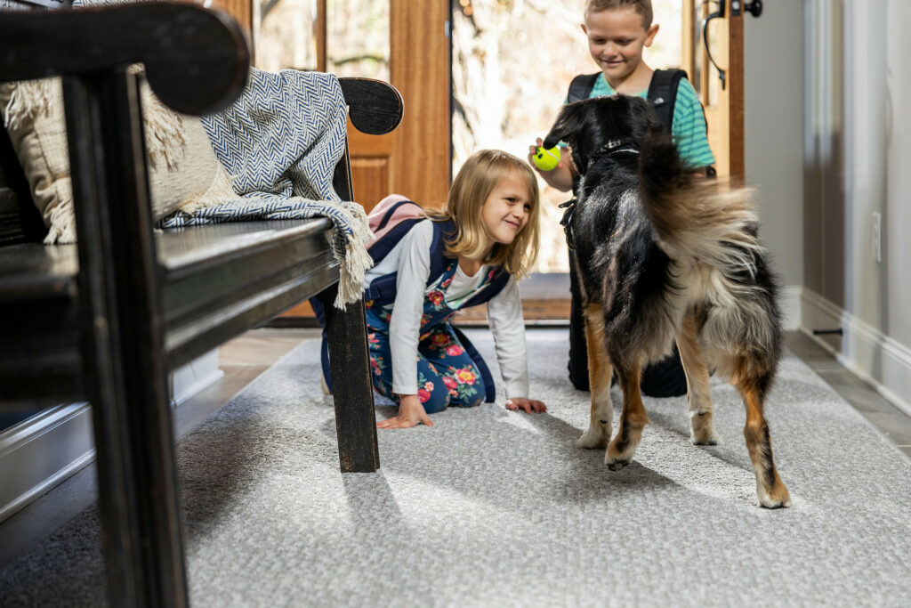 Kids playing with dog on carpet floors | Dary Carpet & Floors